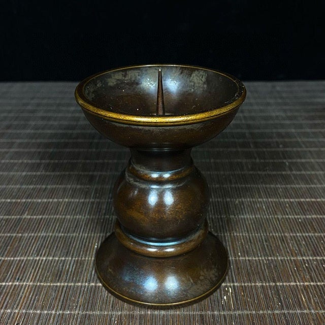 Elevate your tablescape or meditation space with this elegant pair of brass candle holders. Each candlestick features a...