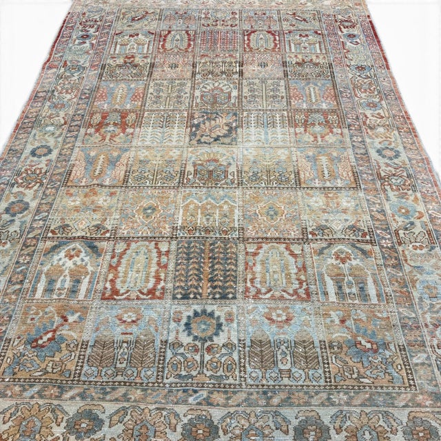 This beautiful antique rug is distinguished by its charming garden-panel design, a particularly decorative composition in...