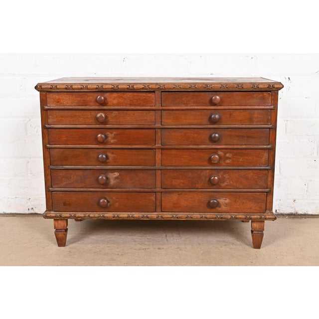 An exceptional Victorian carved mahogany twelve-drawer collector's cabinet USA, Circa 1880s Measures: 25.38"W x 12"D x...