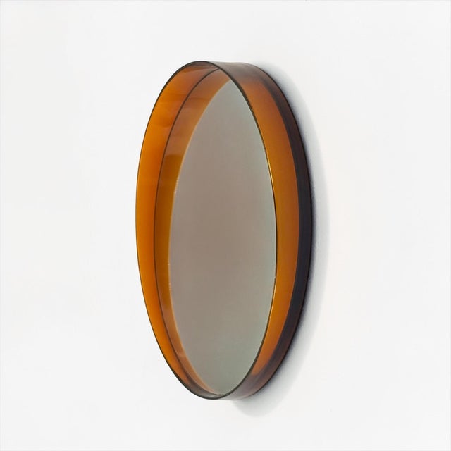 This French Space Age wall mirror from the 1970s stands out for its sculptural presence and distinctive translucent amber...