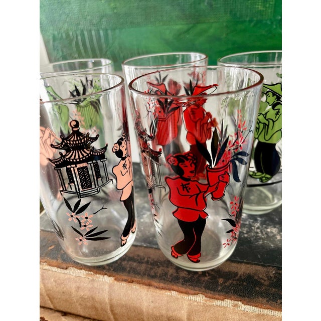 Quirky and kitschy set a vintage barware, these clear glass, tall pieces, each have an Asian man an Asian woman to pick it...