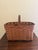 A beautifully woven early 20th century American splint oak basket with warm honeyed tones and a tightly constructed...
