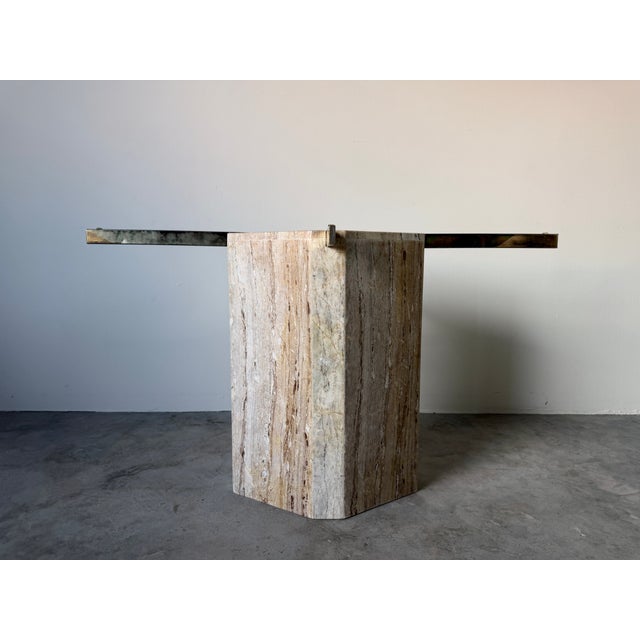 Striking 1980s Postmodern dining table base featuring a substantial architectural marble pedestal with warm beige, cream,...