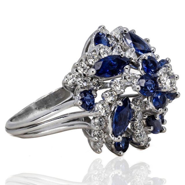 Platinum Ring with 10 round & 5 marquis cut vivid blue sapphires weighing approximately 2.00 carats and 51 round brilliant...