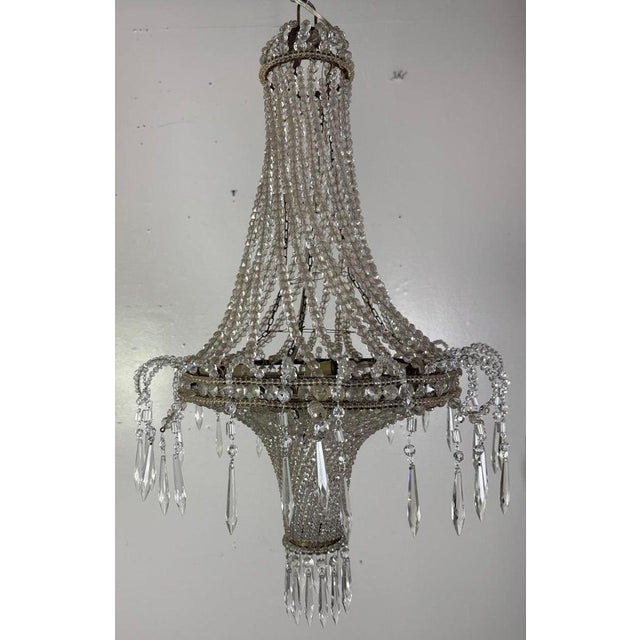 This refined Empire-style chandelier exudes understated opulence with its graceful silhouette and cascading strands of...