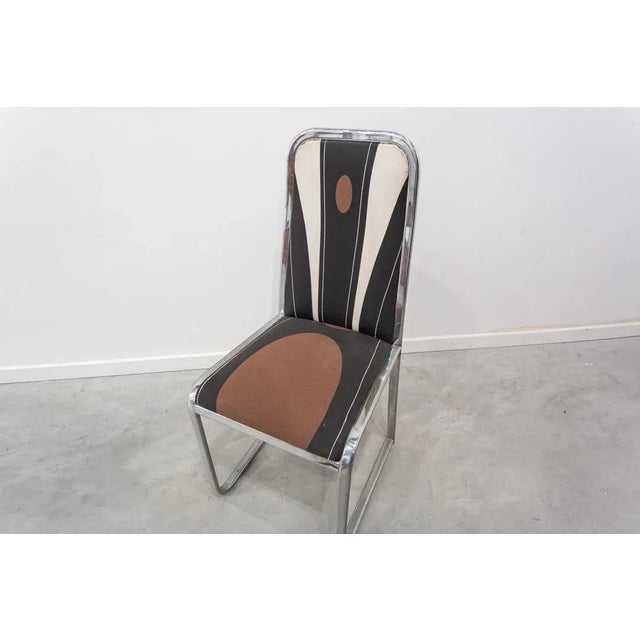 Chair made from a stainless steel plate structure with upholstered seat and backrest. It has been reupholstered following...