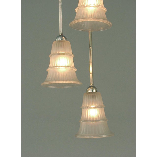 The French are no strangers to the importance of asymmetrical design! This solidly 1930s chandelier beautifully...