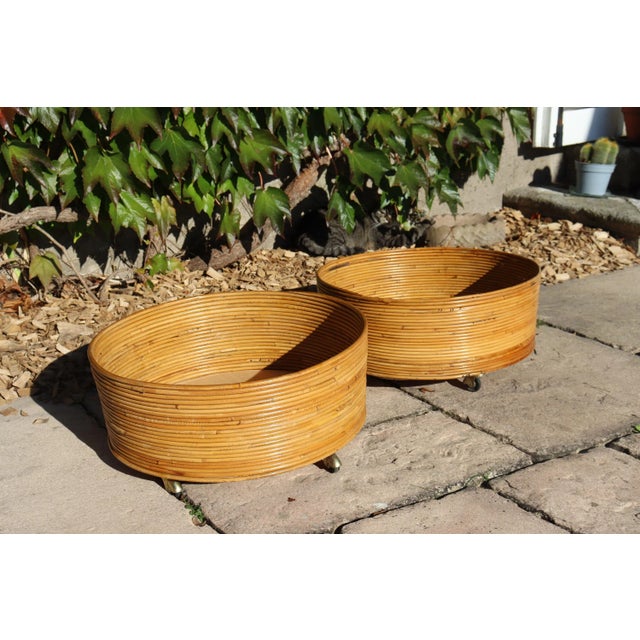 Pair of rattan planters, sourced and manufactured in Italy. 1960s period. Both on wheels. Excellent overall condition.