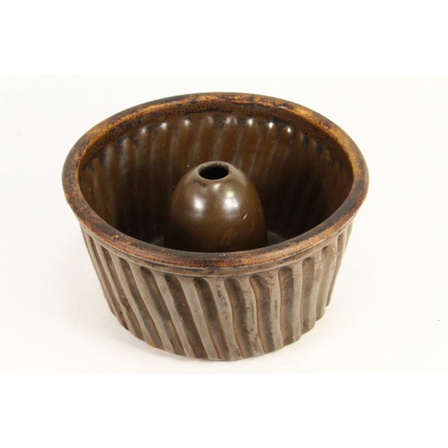 An early cake or pudding mold Glazed earthenware in traditional turban form for baking Bundt cake (the German Gugelhupf...