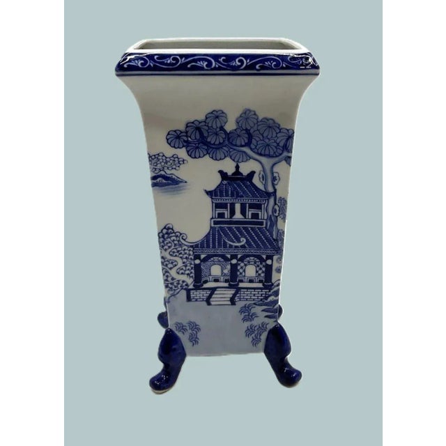 Chinoiserie Vase with Pagoda Scene and Sculptural Feet A rare square-mouthed porcelain vase rendered in classic blue-and-...