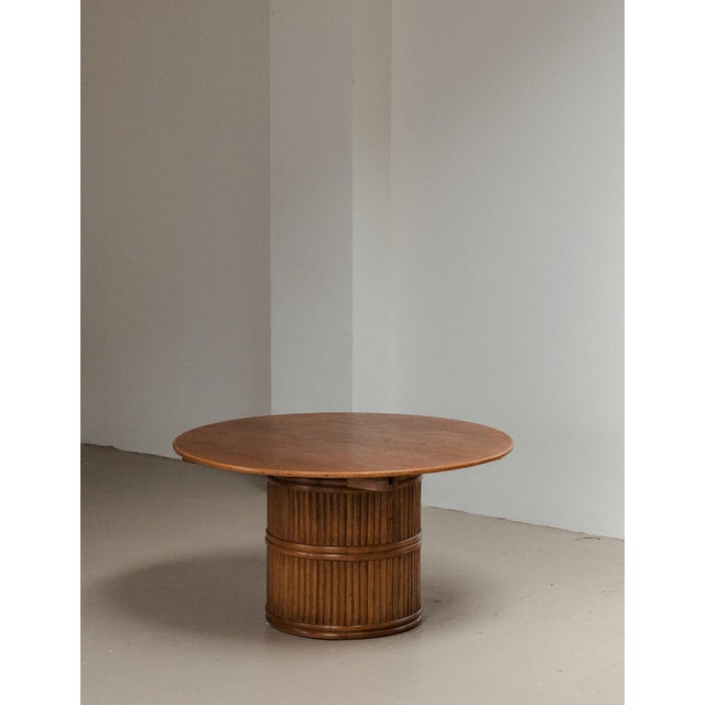 Dining table produced in Italy around 1970. This table has a base finished in dark stained bamboo and a teak table top. It...