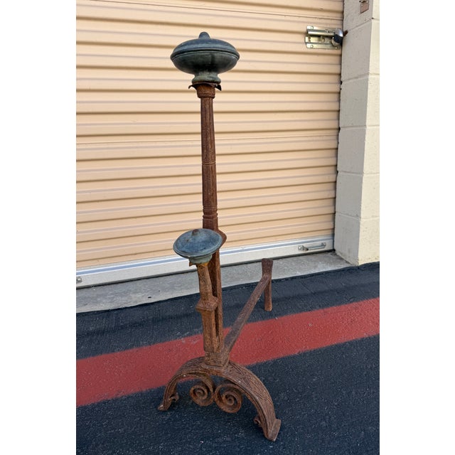 Striking pair of 19th-century carved iron and bronze fireplace andirons featuring exceptional hand-carved detailing and a...