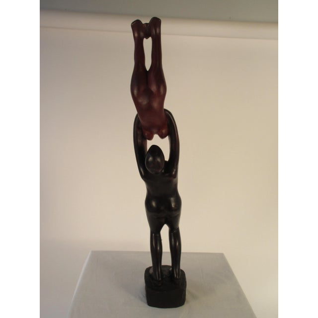 1960s rosewood hand carved sculpture of man and woman. This item includes restricted materials and can not be sold outside...