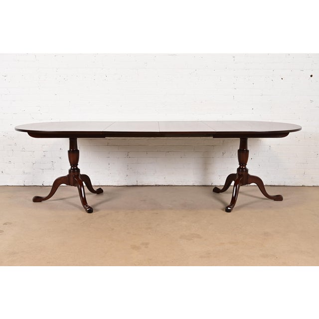 A gorgeous Georgian, Regency, or Queen Anne style solid mahogany double pedestal extension dining table By Kittinger USA,...
