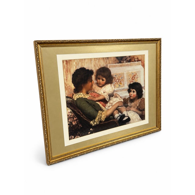 A richly colored figurative reproduction print depicting an intimate domestic scene of a seated mother with two young...