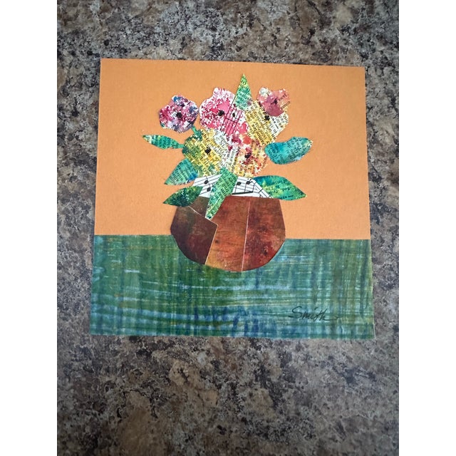 A cheerful mixed-media floral piece created from hand-painted and patterned papers. Bright, textured blossoms and leaves...