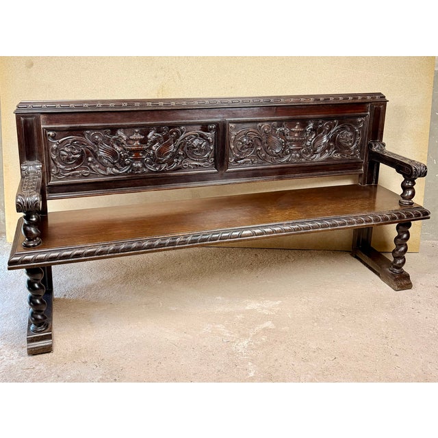 Impressive Spanish bench crafted from wood, featuring richly carved decoration and a strong traditional character. The...