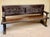 Impressive Spanish bench crafted from wood, featuring richly carved decoration and a strong traditional character. The...