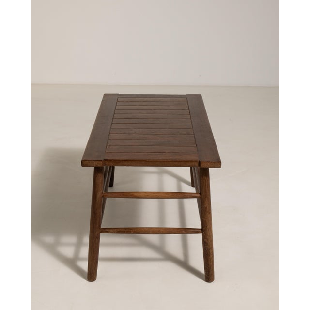 Rendered in richly grained French oak, this distinguished coffee table dates to circa 1960 and reflects the clean,...