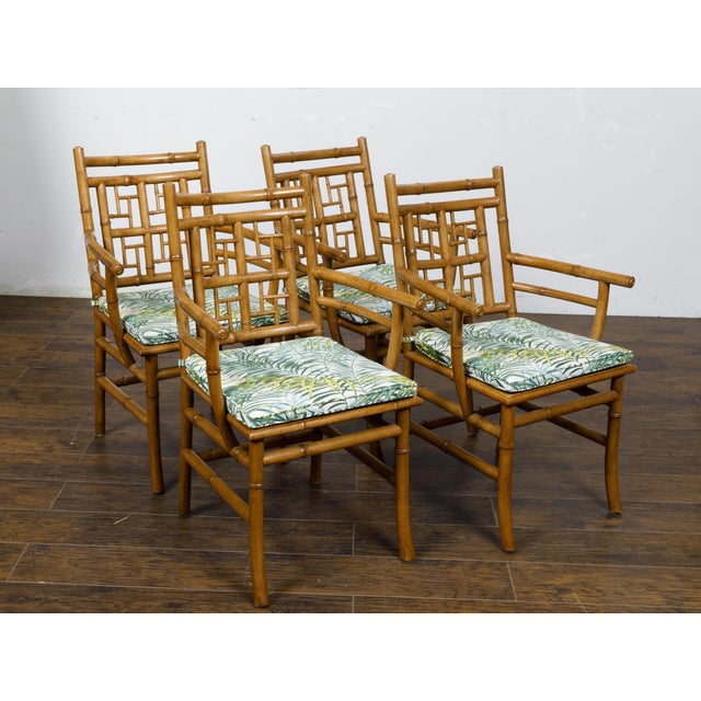 A set of four English Midcentury faux bamboo armchairs with thin cushions. This set of four English Midcentury armchairs,...