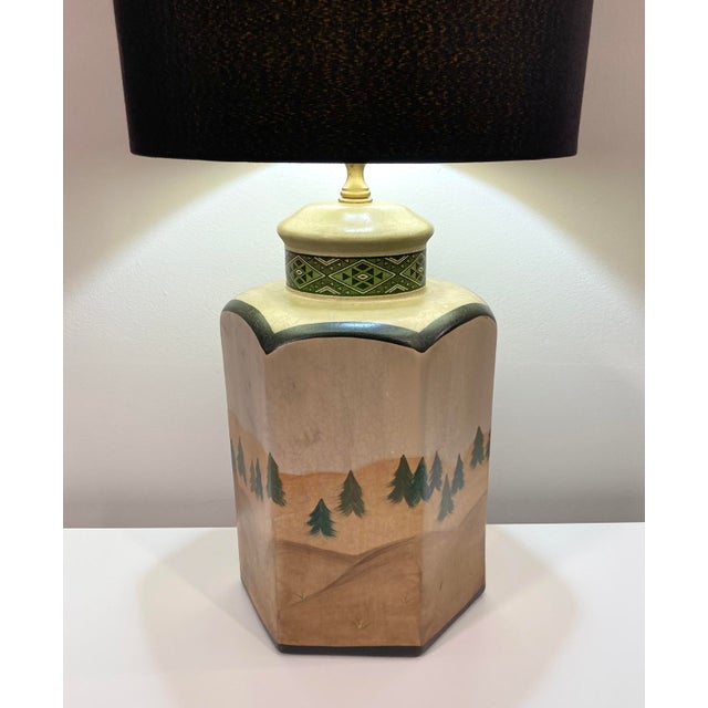 Late 20th Century table lamp from Wildwood Lamps of Rock Mountain, North Carolina. Features a hand-painted pine tree and...