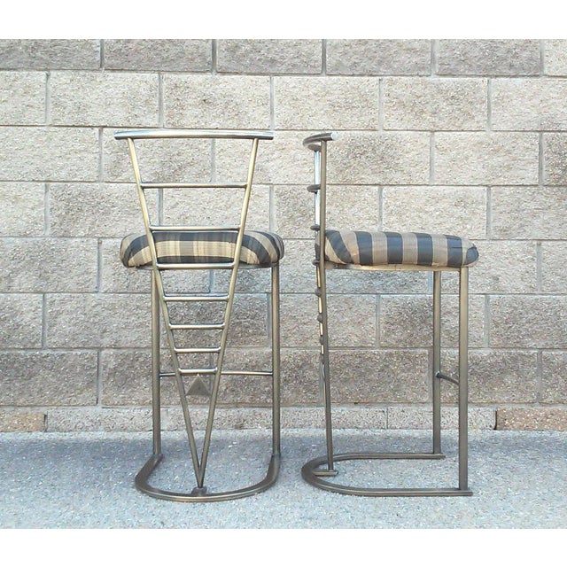 Design Institute of America bronze finished steel Memphis bar stools. No makers mark. Dimensions-Overall 40"H x 18.5"D x...