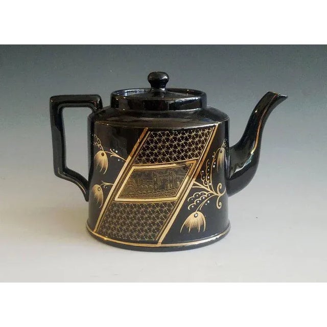 Aesthetic Movement Black-Glazed Pottery Teapot and Cover, Attributed to Dudson, Staffordshire Circa 1885 An English black-...