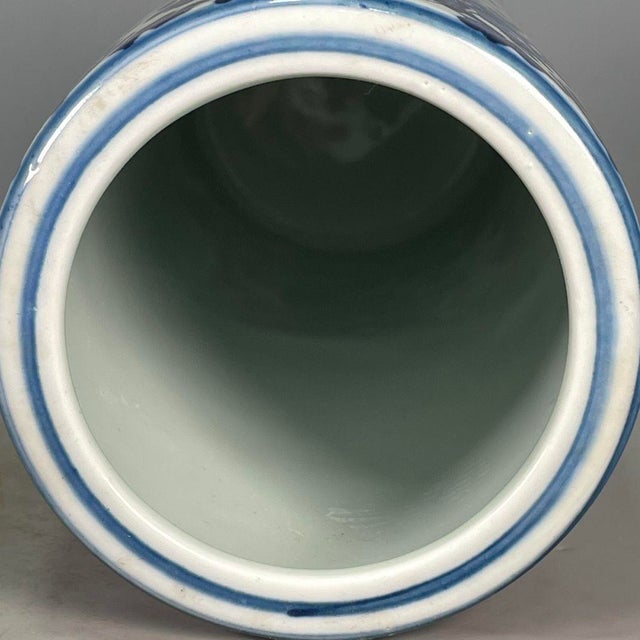 A handsome Chinese blue-and-white porcelain brush pot of tall cylindrical form, painted entirely in traditional cobalt...