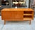 Teak Credenza from Sweden made in the early 1970s. The two side compartments have an adjustable shelf and the exposed...