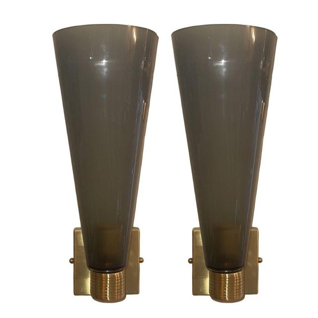 A sophisticated set of four Italian Murano glass sconces in the elegant Impero form, executed in smoked gray glass and...