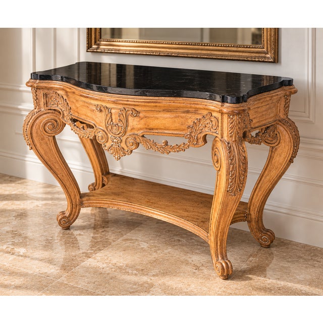 An elegant French Provincial-style console table showcasing an ornate, sculptural silhouette inspired by classic Louis XV...