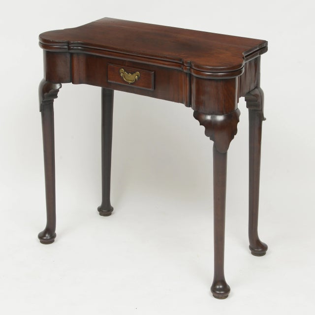 18th century walnut gaming table with green suede playing surface. Fold over table is supported by a single gate leg....