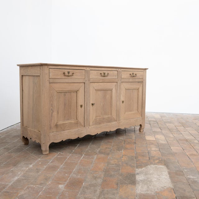 Large antique oak sideboard dating from the 19th century. Its facade, punctuated by three molded-panel doors and three...