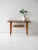 Vintage 1960s Scandinavian coffee table with teak top and tapered turned beech legs. The frame is enhanced by a light...