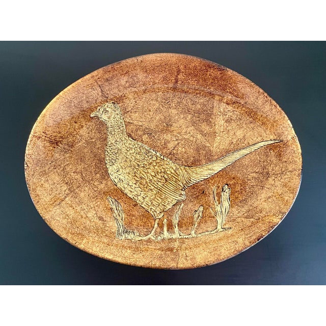 An outstanding vintage glass platter with a bronze and copper finish featuring a pheasant design in the center. The...