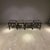 A stylish set of 4 contemporary counter-height stools featuring upholstered seats in a dark gray fabric accented with...