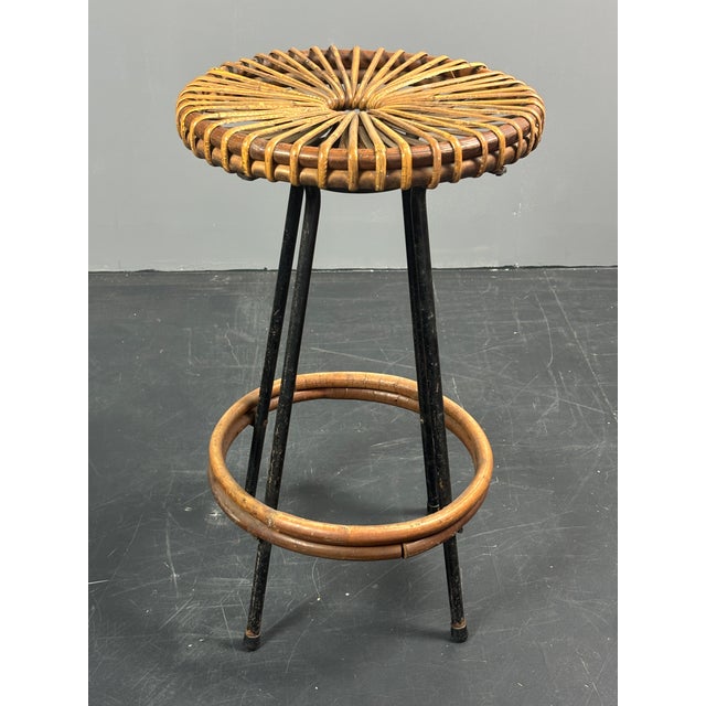 Only visible beneath the seat is a small repair to the rattan ( not visible from above ) This piece is attributed to the...