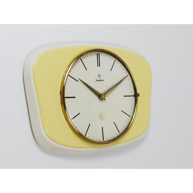 A lovely rectangular mid-century wall clock in landscape format, crafted by Junghans in Germany during the 1950s. Designed...