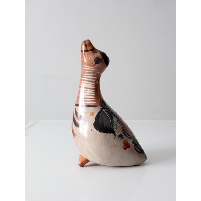 This vintage Tonalá bird figurine from Tonalá is hand-painted in warm neutral tones with expressive floral and feather...