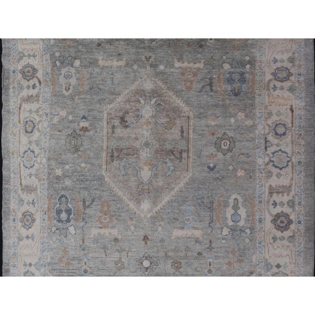 Measures: 7'3 x 10'4 Turkish Modern Oushak Rug in Medallion Design in Gray-Blue, and Marigold. Keivan Woven Arts / rug...