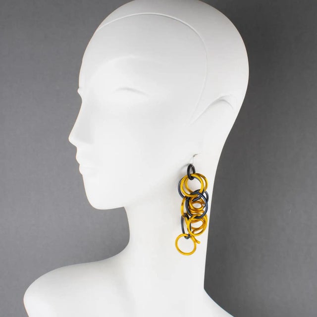 David Spada, New York, designed those incredible dangling pierced earrings. These pieces feature a playful Space Age 1980s...