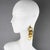 David Spada, New York, designed those incredible dangling pierced earrings. These pieces feature a playful Space Age 1980s...