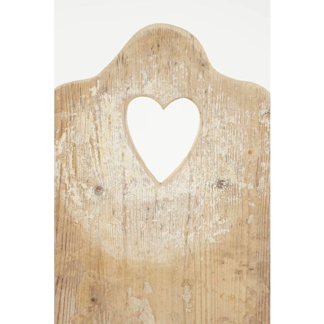 Antique cheese board from France, dating to early 20th century. Heart-shaped handle carved into board. Four available (see...
