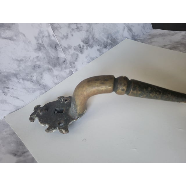This antique door handle is cast from solid iron, weighing 1.4 lbs. Has a great antique patina. There are no markings so I...