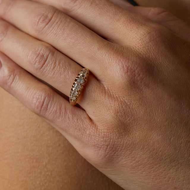 This Victorian old mine cut diamond band is a beautifully romantic antique jewel from the 1880’s, crafted in warm 14k...