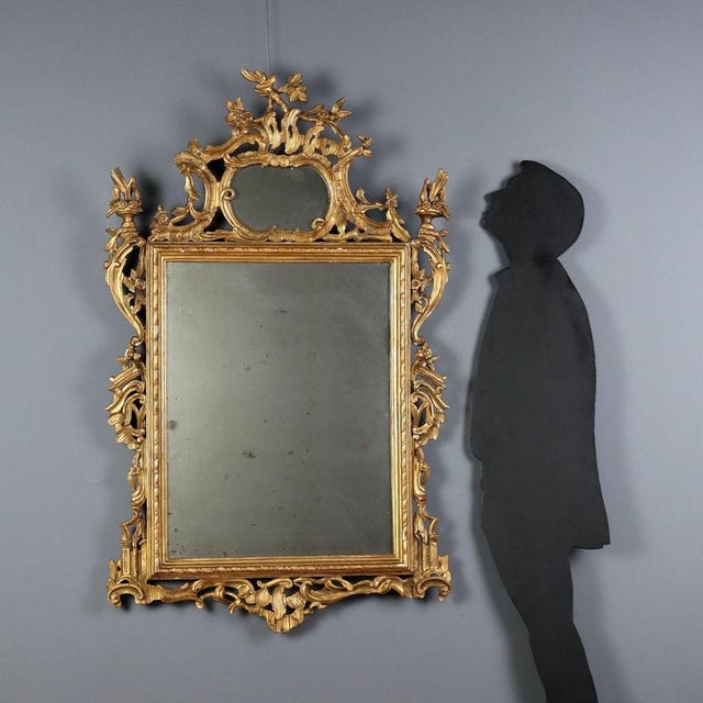 Carved and gilded wood mirror, Italy, late 19th century, featuring a molded frame with a cord carving enclosing a mercury...