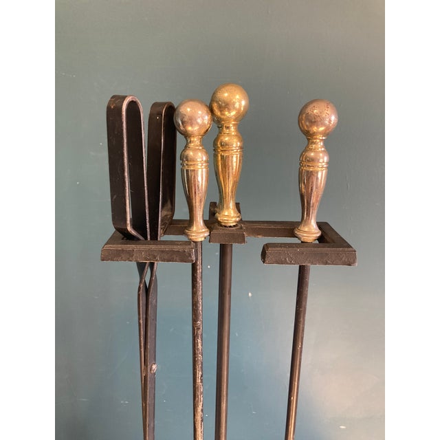 This vintage fireplace tool set features a solid iron stand accented with classic brass finials, offering both durability...