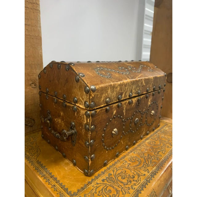Early 20th Century Antique Spanish Leather Dome-Top Chest Studded with Brass Nailhead Detail. Interior is Lined with Red...