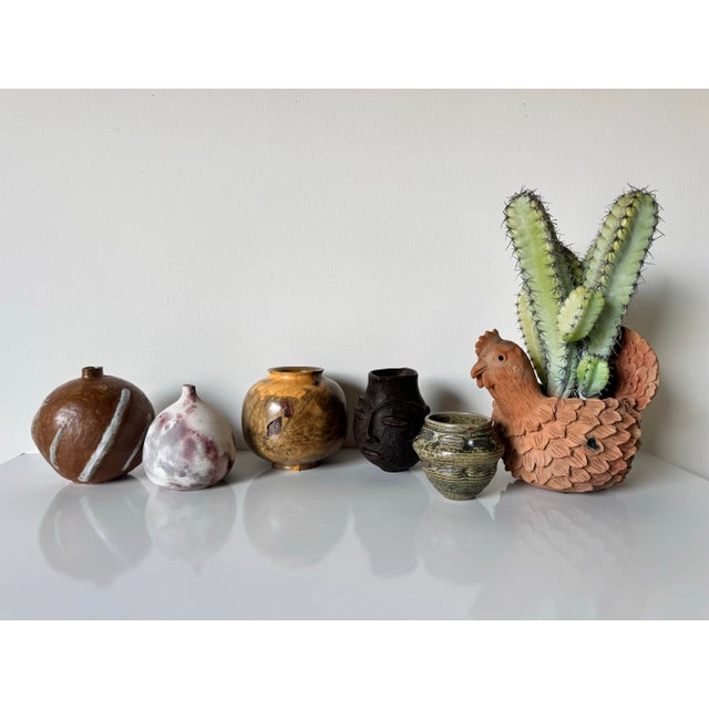 This striking vintage African face vase is a beautifully handcrafted piece, carved from solid wood with a rich, dark...