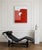 An abstract composition with soft, organic lines, where two red forms seem to meet in silent equilibrium. The terracotta...